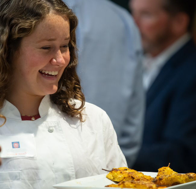 NHM student works at a school function as a server.