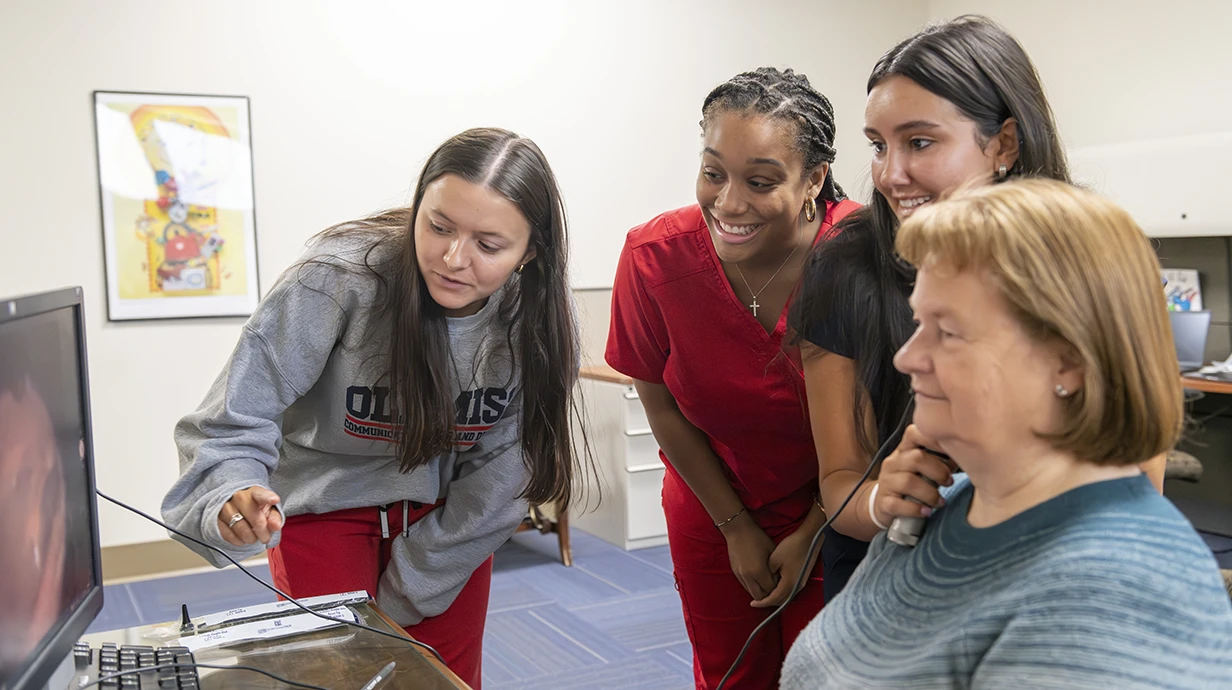 Communication Sciences & Disorders (CSD) students assist a patient during an Audiology Hands-On Clinical. CSD majors learn the anatomy and physiology of speech, language, and auditory processes, and get hands-on experience assessing and managing disorders in speech, language, and hearing.