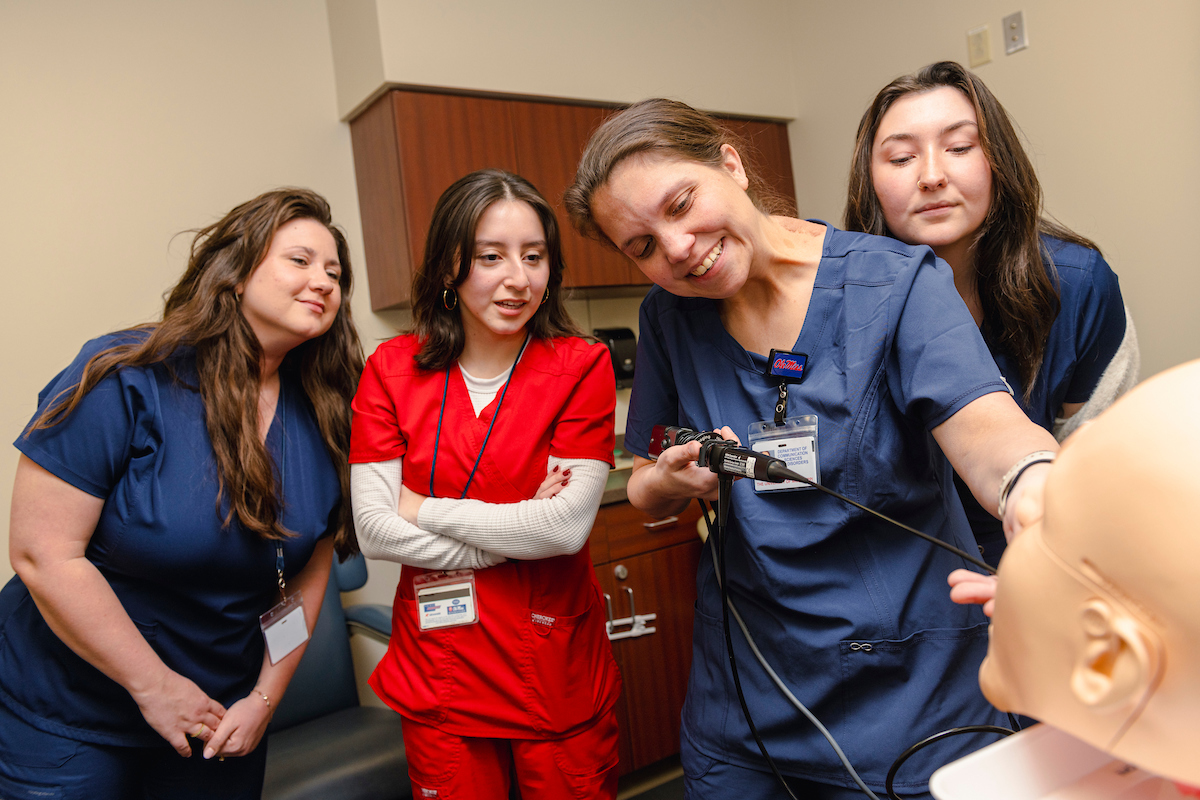 Students learn about new tools from a professor with CSD at the School of Applied Sciences at Ole Miss