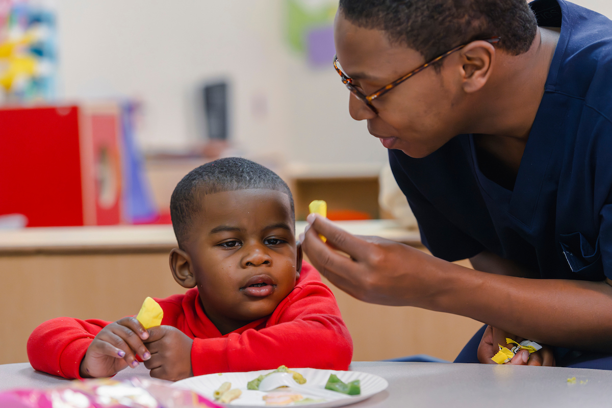 Student with CSD works with a child - School of Applied Sciences Ole Miss